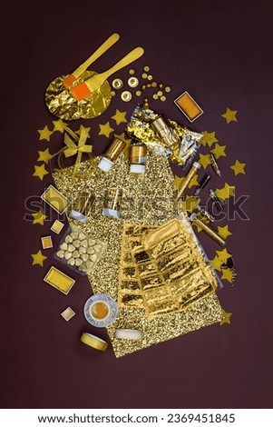 Still life of golden color accessories. Expertise decorating items with gold colored in workshop. Gilding of beaten gold.