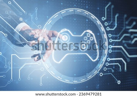 Close up of businessman hand pointing at creative joystick or gamepad hologram on blurry background. Esport, gaming and fun concept