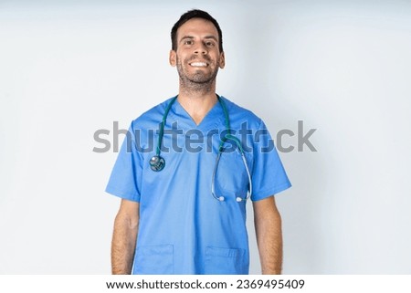 young doctor man wearing medical uniform with a happy and cool smile on face. Lucky person.