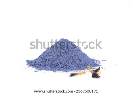 Heap of blue matcha powder from clitoria flowers on a white background. Butterfly pea blue matcha powder with dried flowers.