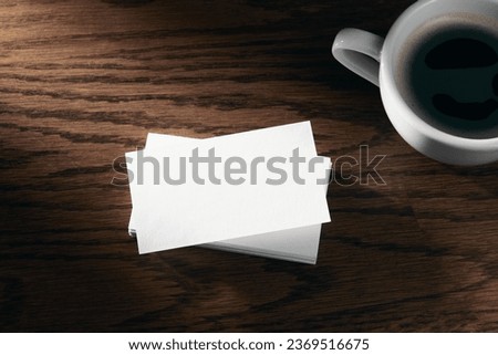 Modern business card mockup template with copy space. Design presentation layouts for corporate identity, advertising, personal, stationery on table with coffee cup. Concept of entrepreneurship.