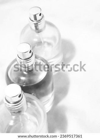 Black and white glass bottles filled with liquid, vintage retro edit, vertical orientation