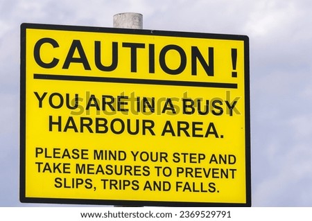 Sign at a harbour warning visitors that there will be hazards