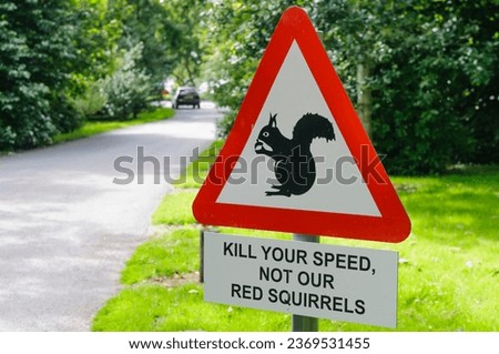 Warning sign asking motorists to slow down and take care with red squirrels
