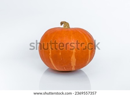 Pumpkin (Red kuri squash; Hokkaido) on white background isolated with reflection