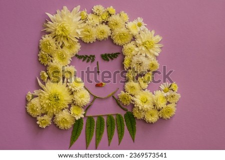 tiny face of girl made from white chrysanthemum and daisy flowers, isolated on purple violet background