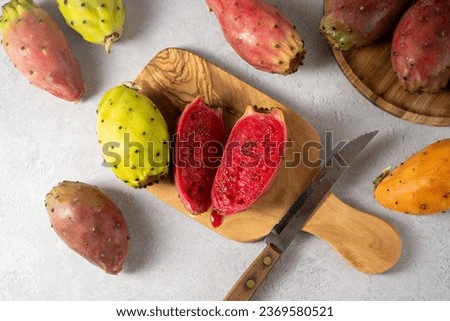 Prickly pears, exotic cactus fruits cut in halves, top view. Royalty-Free Stock Photo #2369580521