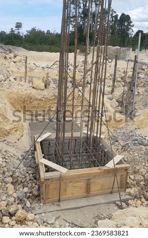 The chicken claw foundation (footplate) consists of a concrete slab as a base with an iron frame to strengthen the building structure Royalty-Free Stock Photo #2369583821