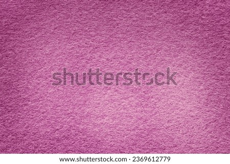 Felt fabric texture background in pink violet color with copy space for design.