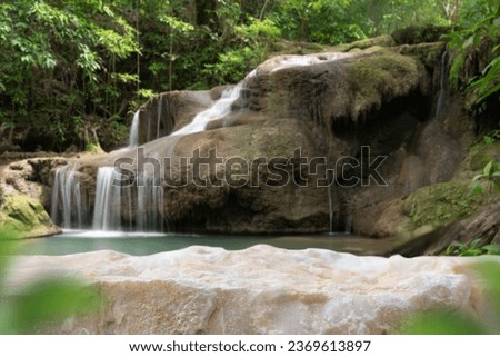 Stone table top podium floor in outdoor waterfall green tropical forest nature background.Natural water product present placement pedestal counter display, spring summer jungle paradise concept.