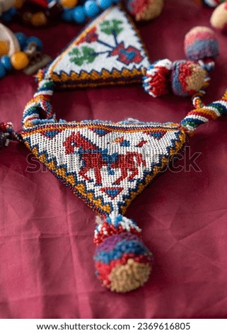 Beaded and decorated muska cover in a flea market. Muska an object in the shape of a triangle with a prayer written inside and believed to protect believers.