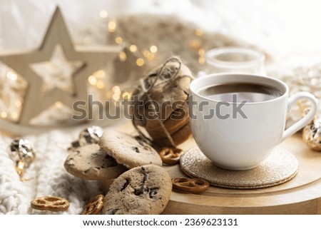 Winter composition with a cup of cocoa and marshmallows on a blurred background.