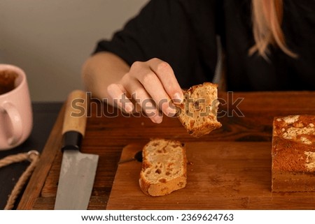 female hands holding a cupcake over the table