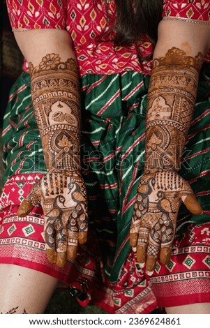Indian Bride Displays Mehndi Designs with Bridesmaids Henna Adorned Hands, Hand mehndi designs are being prepared and ready for the Wedding function. Royalty-Free Stock Photo #2369624861