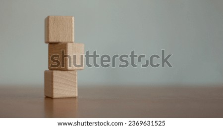 Three blank wooden blocks stacked on a blurred background. Royalty-Free Stock Photo #2369631525