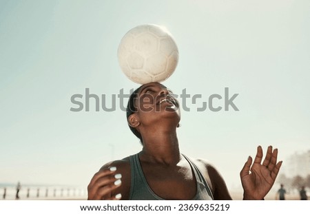 Head balance, sports and soccer ball with woman athlete in the sun and nature. Fitness, balancing concentration and football exercise of a black person busy with workout, training and healthy cardio