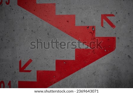 Exit stairs information inside a building with up and down arrows.
