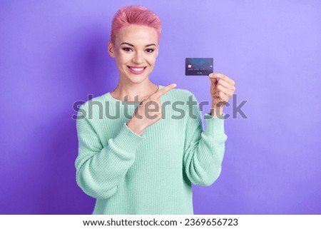 Portrait of charming girl indicate finger hand hold debit card isolated on purple color background