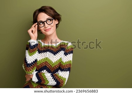 Photo of dreamy thoughtful girl dressed striped clothes hand arm eyewear looking empty space isolated green color background
