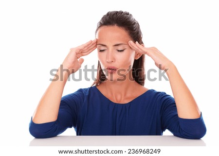 Pretty female with closed eyes suffering headache in white background