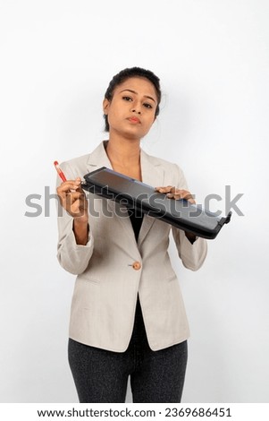 Corporate office lady holding a folder, pen and giving presentation. Young woman in formal wear wearing white blazer against white background.