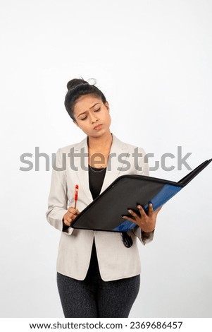 Corporate office lady holding a folder, pen and giving presentation. Young woman in formal wear wearing white blazer against white background.