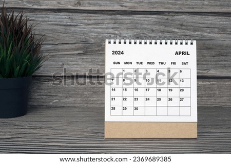 White April 2024 calendar on wooden desk with potted plant. 2024 New Year Concept Royalty-Free Stock Photo #2369689385