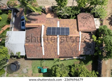 House area with solar panel system on roof above top drone view