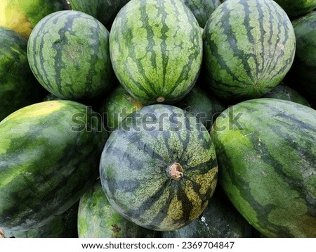 'FRESH FROM THE FARM'. The picture shows a pile of fresh watermelons just picked from the farm and placed on the table.