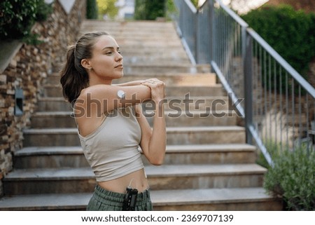 Beautiful diabetic woman preparing for outdoor run in the city. Royalty-Free Stock Photo #2369707139