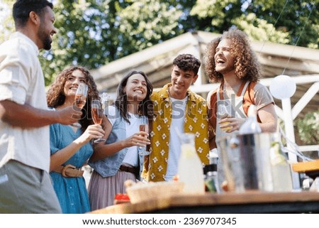 Friends and family talking and having fun at a summer grill garden party.