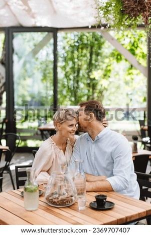 Portrait of beautiful couple in a restaurant, on a romantic date. Royalty-Free Stock Photo #2369707407