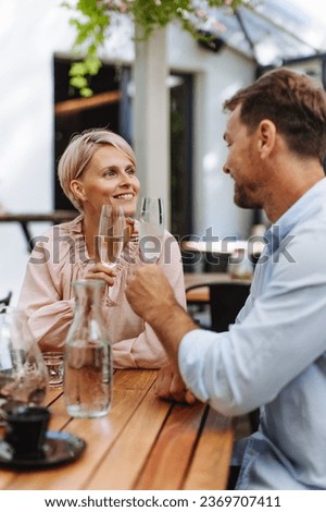 Portrait of beautiful couple in a restaurant, on a romantic date.