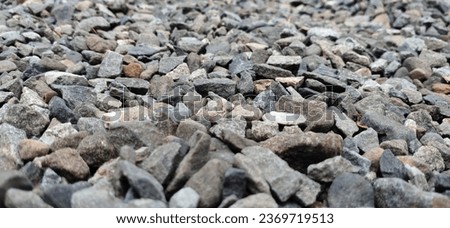 the rough surface of gravel or crushed stone that has been processed and crushed is called split gravel, paving layers, building materials, home and garden yard layers, rock backgrounds and textures. Royalty-Free Stock Photo #2369719513
