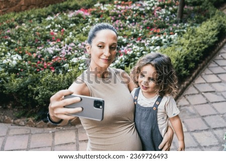 woman and her little son taking a selfie while traveling sightseeing in the city of Cáceres