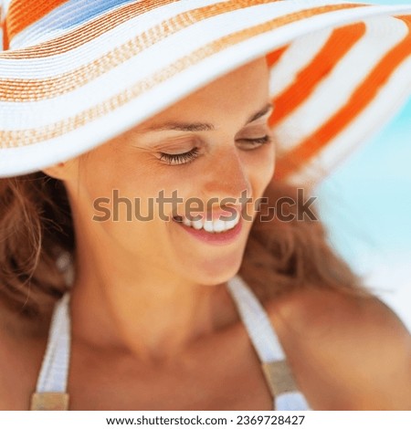 happy young woman in hat on beach