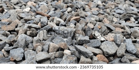 the rough surface of gravel or crushed stone that has been processed and crushed is called split gravel, paving layers, building materials, home and garden yard layers, rock backgrounds and textures. Royalty-Free Stock Photo #2369735105