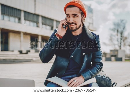 caucasian man making smartphone conversation during exam preparation