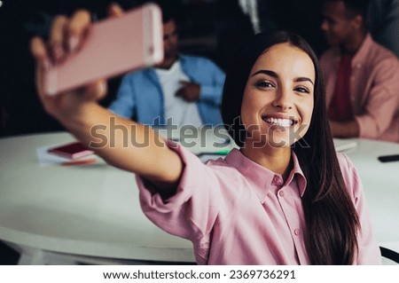 positive female holding modern cellular phone