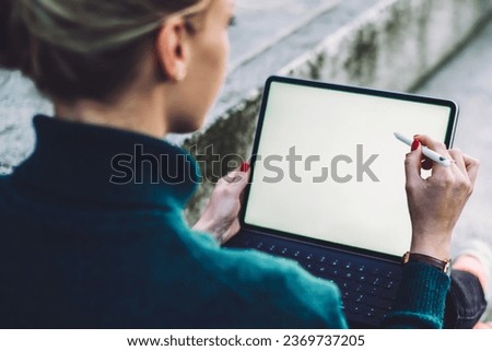 female digital nomad working remotely on blank touch pad