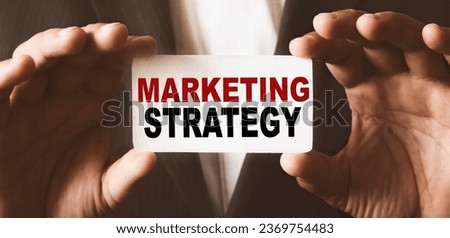 Front view, hands of African business man holding a business card. The content of the lettering has implications for business concept and marketing.