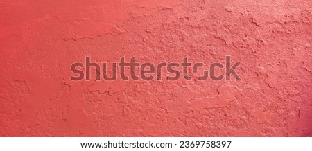 Abstract red painted rough cement wall textured background. Abstract colorful banner made of concrete rough wall.