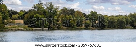 Levee on sacramento river panorama with drainage pipe 