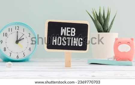 Web Hosting text written on paper next to scattered paper clips, calculator, adhesive paper.