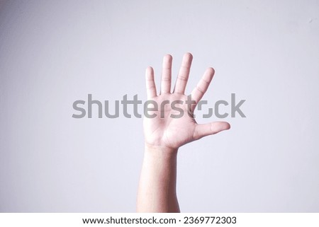 Five fingers isolated on white background. Man shows his hand stop sign