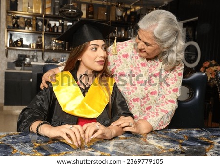 Happy young girl with her Grand Mother on graduation day