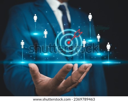Businessman shows dart board in selecting business target group, target customers, buyers, customer behavior concept, marketing plan and strategy, personal marketing, customer centric strategy.