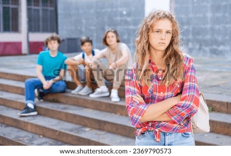 Portrait of offended girl after quarrel with friends outdoors
