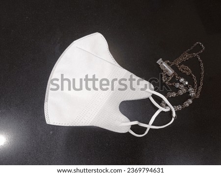 a picture of white mask with pearl strap
