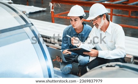 Metalwork manufacturing factory manager inspect newly manufactured metal or steel roll and frame in factory. Inspection and quality control process ensure highest quality product. Exemplifying Royalty-Free Stock Photo #2369837979